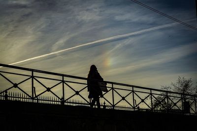 Low angle view of silhouette bridge against sky at sunset