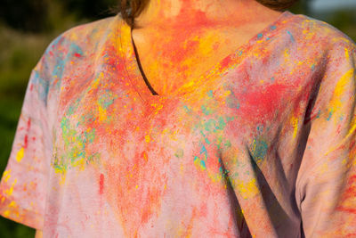 Cropped image of woman in t-shirt covered colourful holi powder paint.