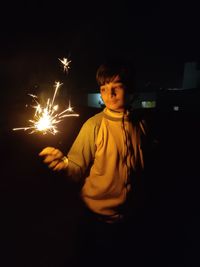 Boy looking away at night