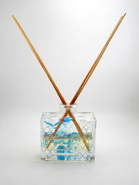 Close-up of glass container on table against white background