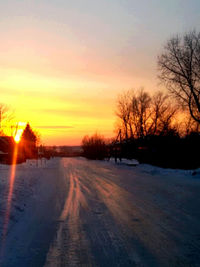 Snow covered landscape at sunset