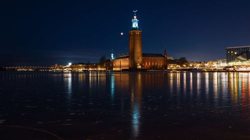 Reflection of illuminated buildings in water at night