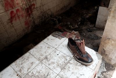 High angle view of shoes on floor in abandoned building