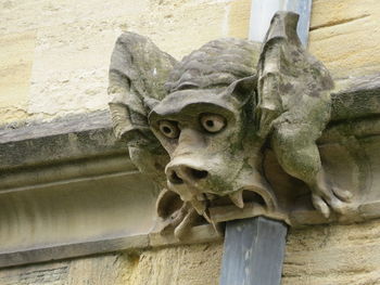 Low angle view of lion statue against wall