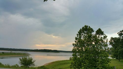 Scenic view of lake against cloudy sky