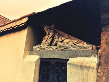 Close-up of statue against built structure