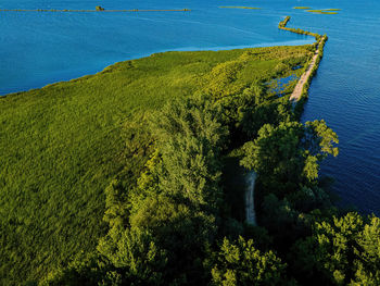 A desolate view as the sun shines over the fox river with a view of the breakwall near oshkosh