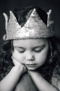 Close-up portrait of cute girl wearing crown