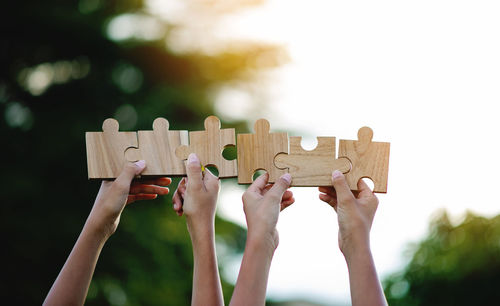 Cropped hand holding jigsaw pieces