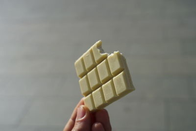 Close-up of hand holding ice cream against blurred background