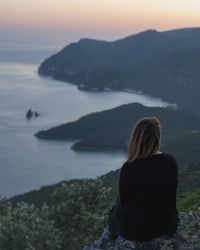 Rear view of woman looking at sea against sky