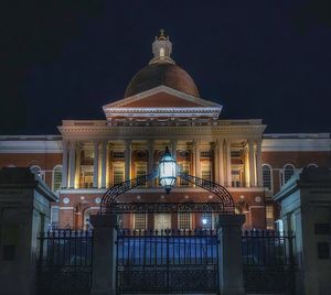 Illuminated building against sky at night