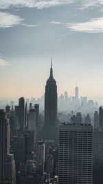 Modern buildings in city against sky