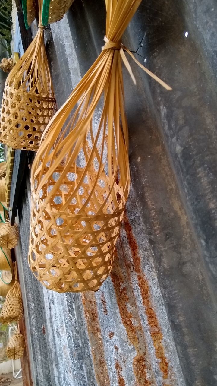 CLOSE-UP OF WICKER BASKET HANGING ON TABLE