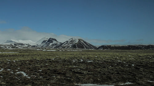 Scenic view of snowcapped mountains against clear blue sky