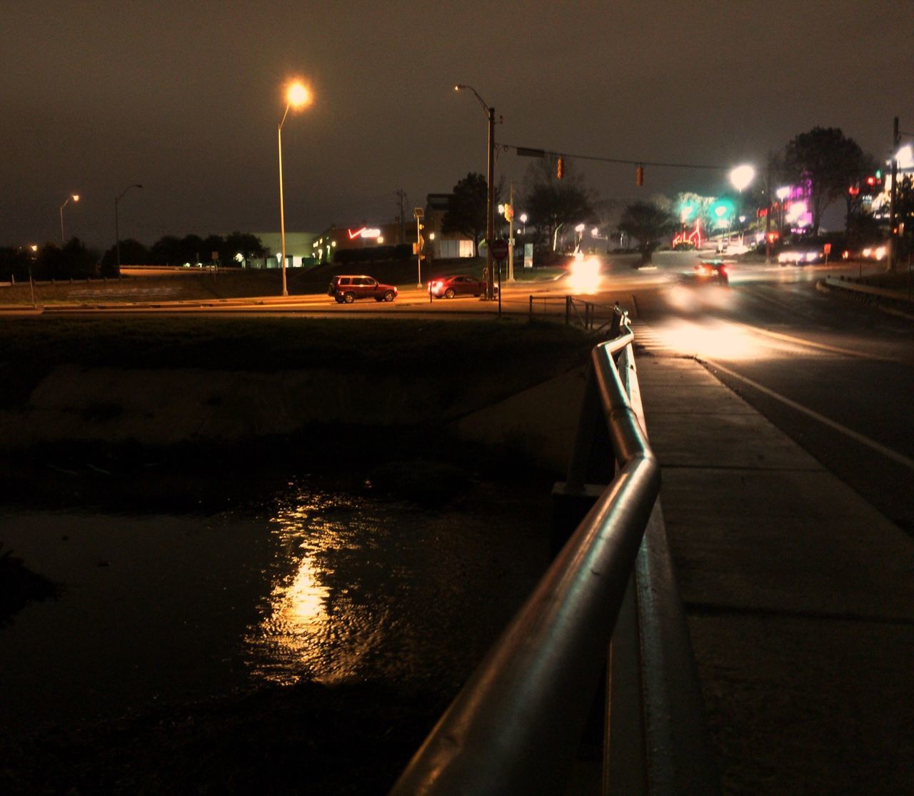 night, illuminated, street light, transportation, street, lighting equipment, mode of transport, road, sky, city, reflection, car, water, dark, building exterior, outdoors, light - natural phenomenon, no people, land vehicle, the way forward