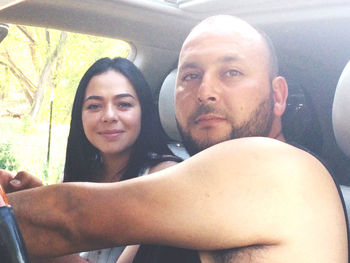 Portrait of young couple in car