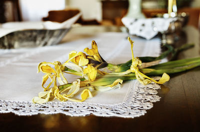 Close-up of yellow rose on table