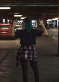 Rear view of woman photographing in bus