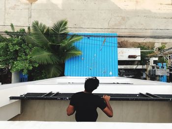 High angle view of man leaning on railing