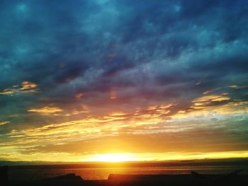 Scenic view of dramatic sky over sea during sunset