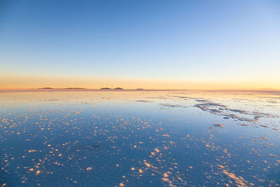 Scenic view of sea against clear sky during sunset