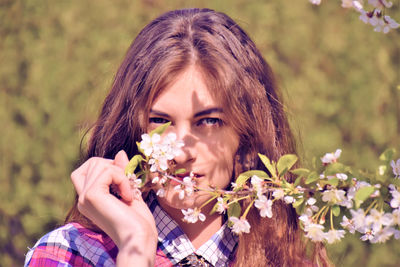 Close-up of woman holding flower