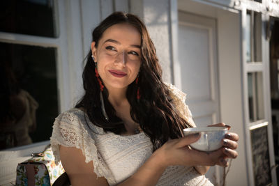 Portrait of young woman drinking coffee