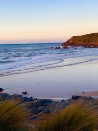 Scenic view of sea against clear sky during sunset