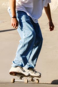 Low section of man skateboarding