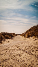 Scenic view of sand dunes against sky