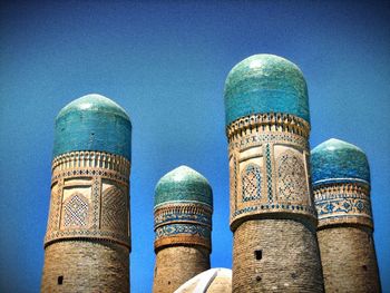 Low angle view of tower against blue sky