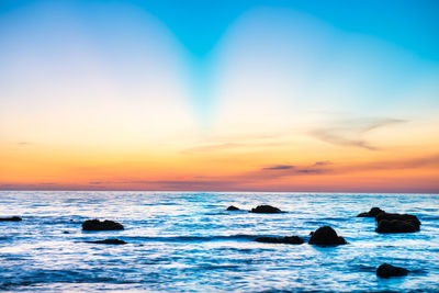 Scenic view of sea against sky during sunset