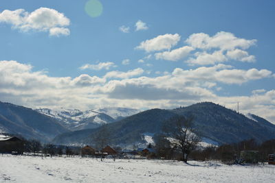 Scenic view of snowcapped mountains against sky