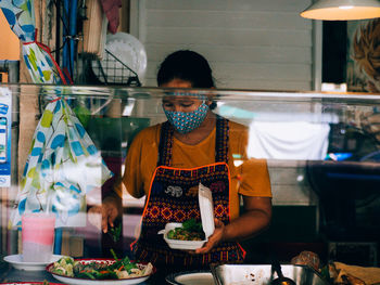 Midsection of woman standing at market stall