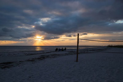 Scenic view of beach against sky during sunset