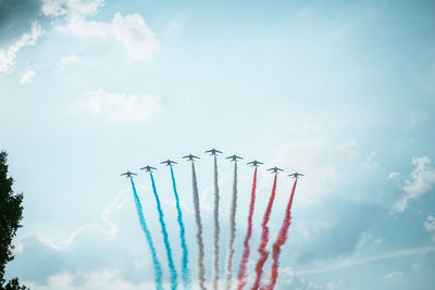 Low angle view of airshow against sky