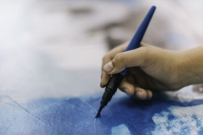 Close-up of human hand holding paper