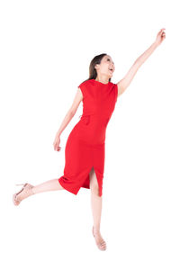 Full length of young woman standing against white background