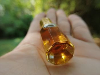 Close-up of hand holding glass bottle