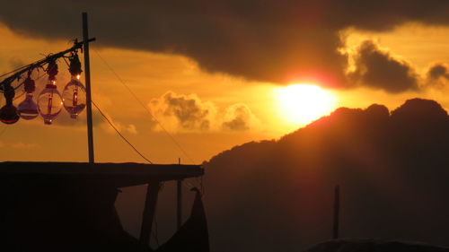 Silhouette sailboat against sky during sunset