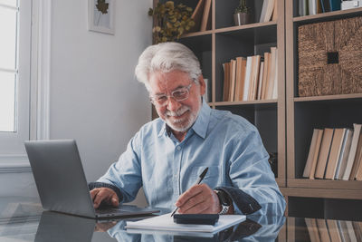 Portrait of smiling man sitting at table