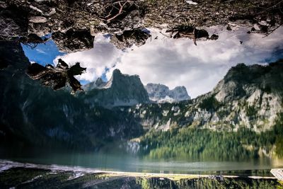 Upside down view of calm lake with mountains reflection