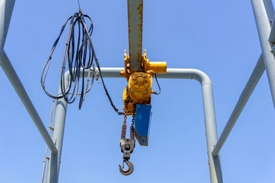 Low angle view of crane against sky