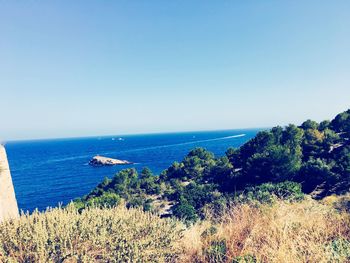 Scenic view of sea against clear blue sky