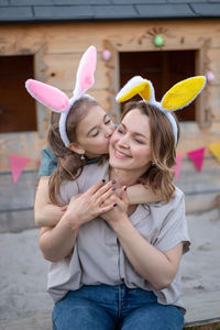 Mother and daughter wearing rabbit ears