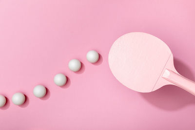 Directly above shot of pills on pink background