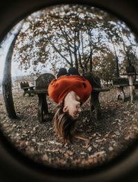 Portrait of woman with camera in park