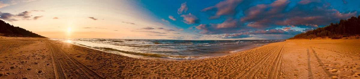 Panoramic view of beach against sky during sunset