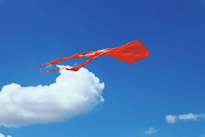 Low angle view of flag against blue sky